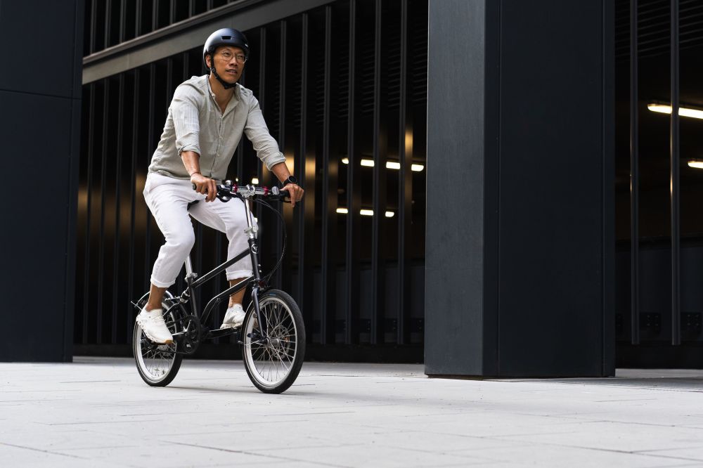 c_BMIMI_Sabine_Sattlegger.jpg Radfahrer im legeren Businessoutfit auf einem Faltrad